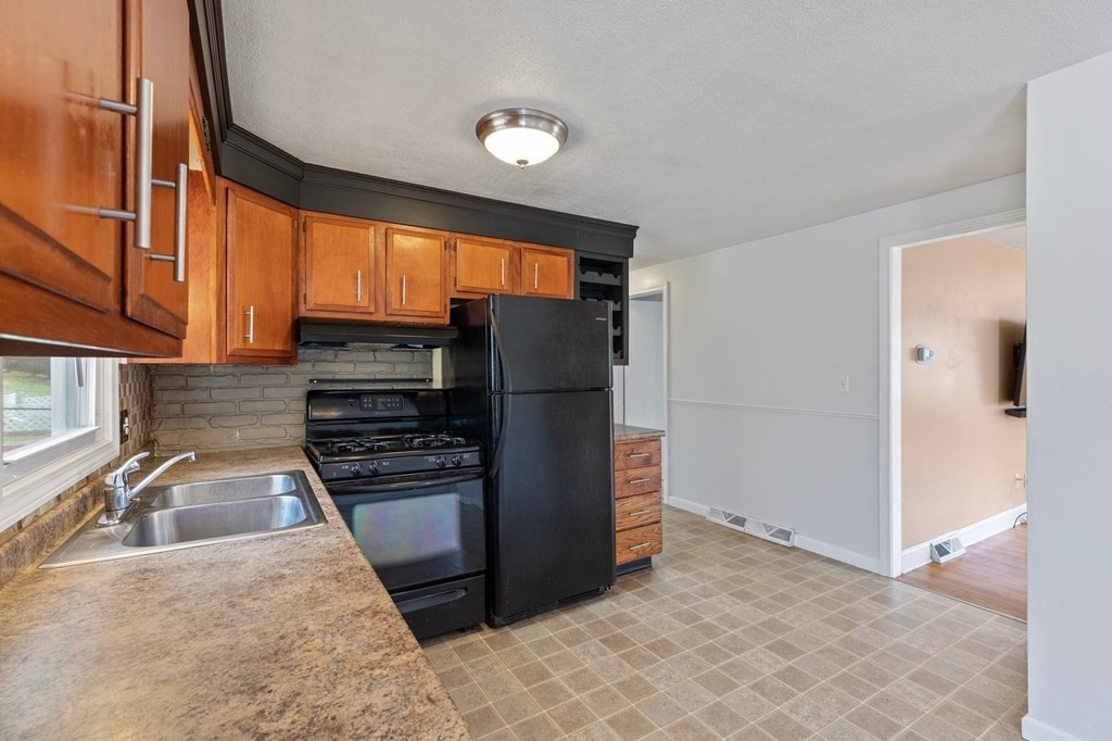 151 Garnet Street Springfield, MA 01129 - Photo 12 of 41 a kitchen with granite countertop a refrigerator and a sink
