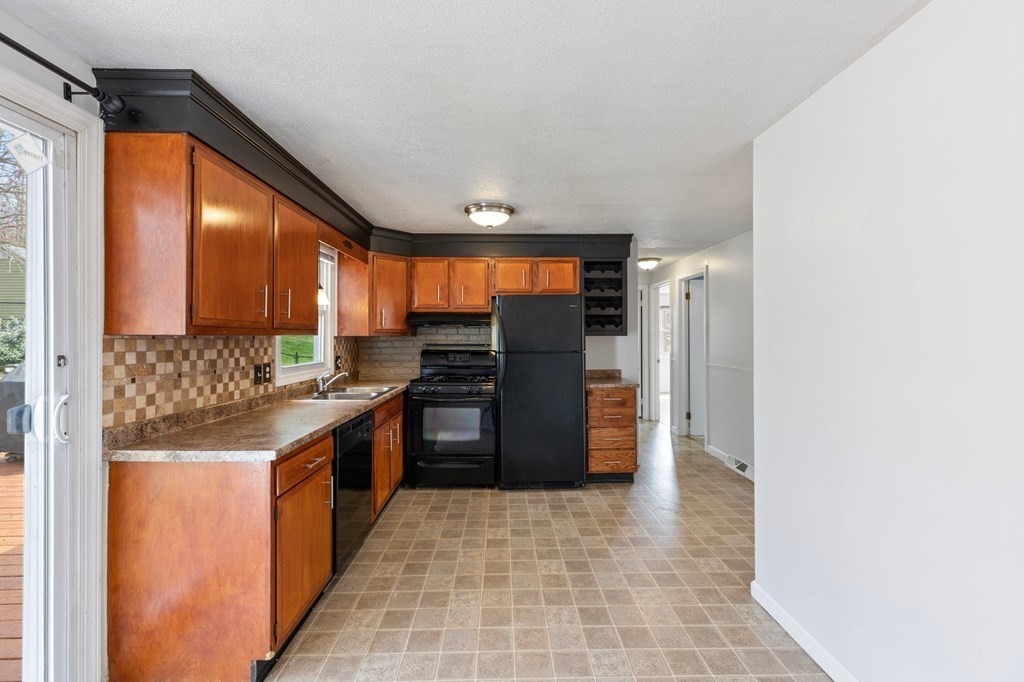 151 Garnet Street Springfield, MA 01129 - Photo 17 of 41 a kitchen with stainless steel appliances granite countertop a refrigerator and a stove