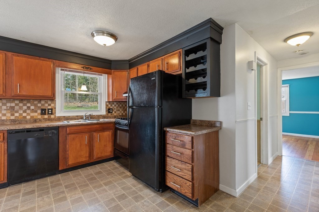 151 Garnet Street Springfield, MA 01129 - Photo 18 of 41 a kitchen with stainless steel appliances granite countertop a refrigerator and a stove