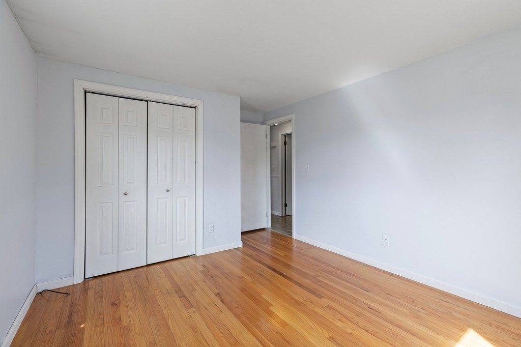 151 Garnet Street Springfield, MA 01129 - Photo 22 of 41 a view of an empty room with wooden floor