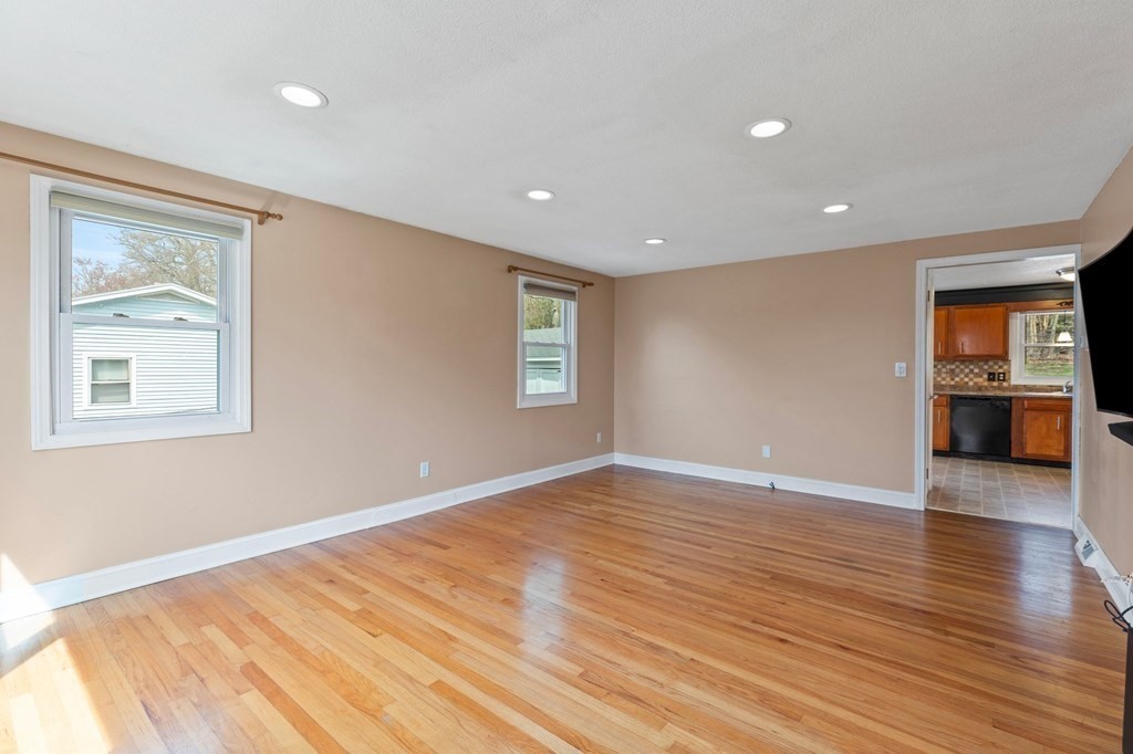 151 Garnet Street Springfield, MA 01129 - Photo 3 of 41 a view of a big room with wooden floor and windows