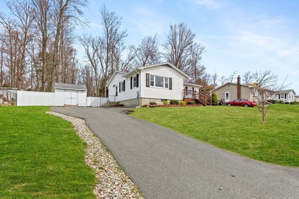 151 Garnet Street Springfield, MA 01129 - Photo 40 of 41 a view of a house with a big yard and large trees
