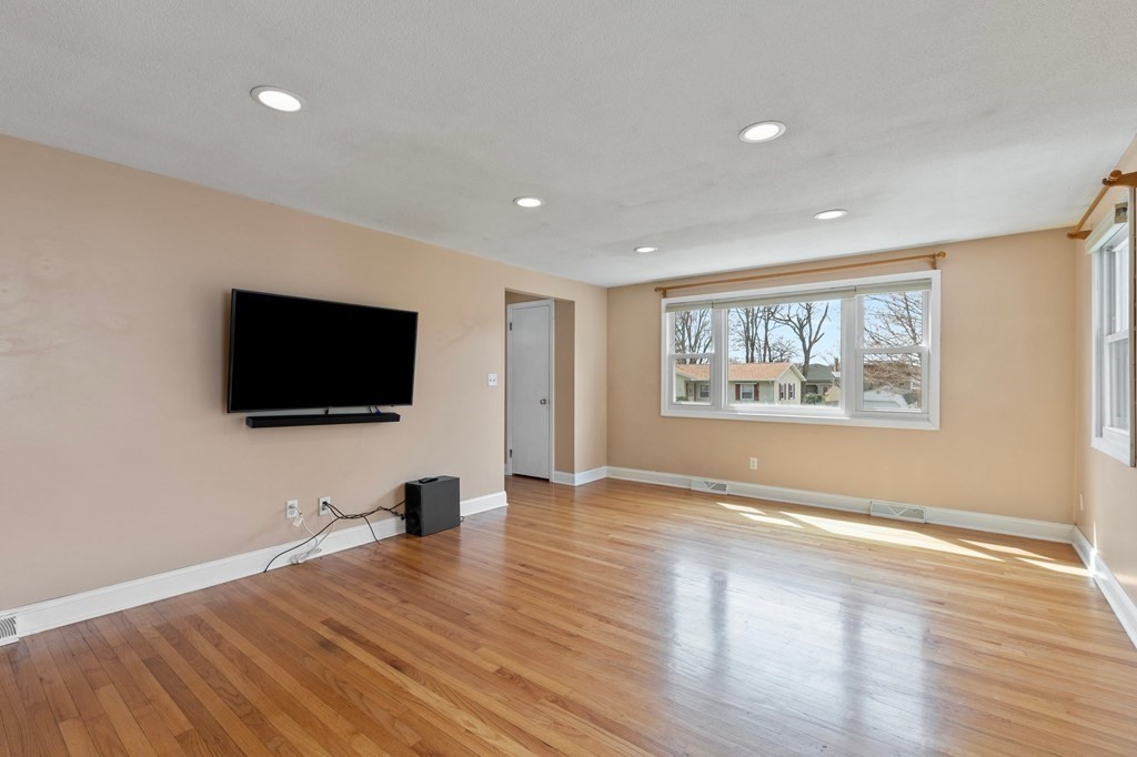 151 Garnet Street Springfield, MA 01129 - Photo 4 of 41 a view of a livingroom with a flat screen tv and wooden floor