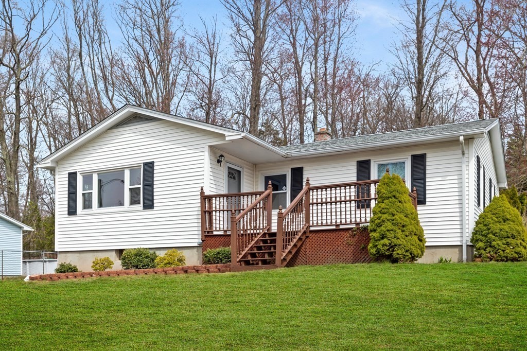 151 Garnet Street Springfield, MA 01129 - Photo 41 of 41 a front view of a house with a garden and trees