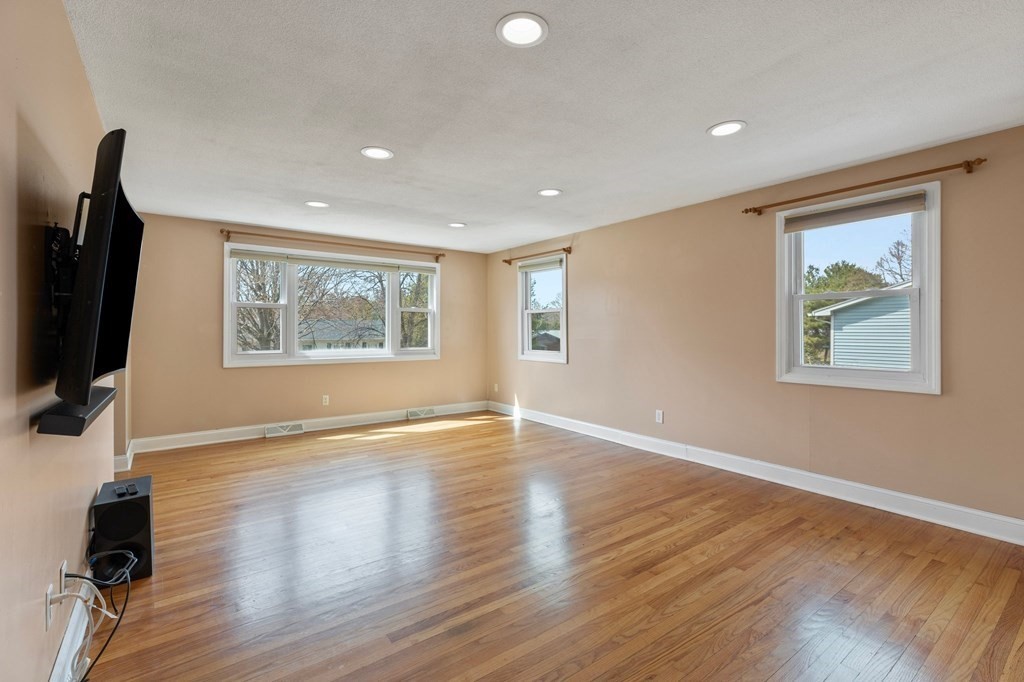 151 Garnet Street Springfield, MA 01129 - Photo 5 of 41 a view of an empty room with a window and wooden floor