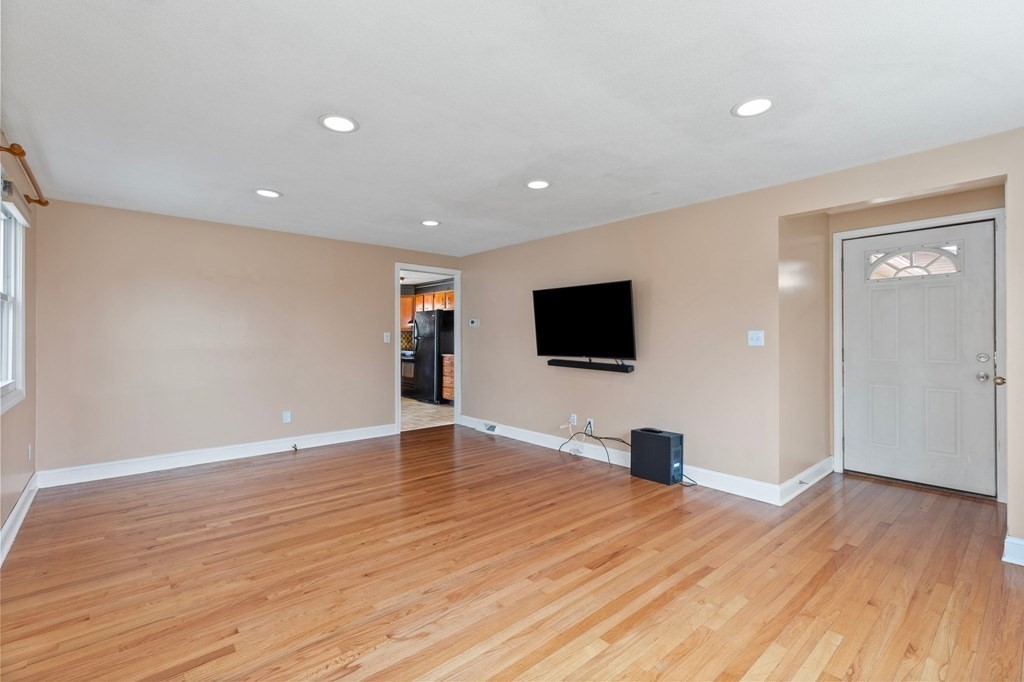 151 Garnet Street Springfield, MA 01129 - Photo 6 of 41 a view of room with wooden floor and flat screen tv