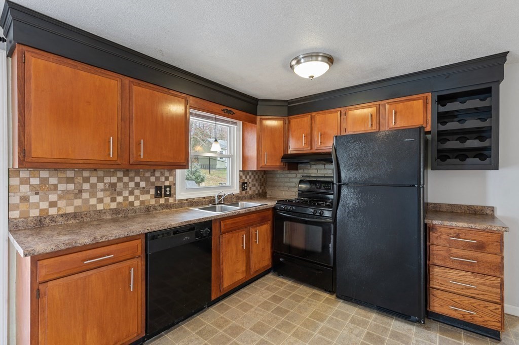 151 Garnet Street Springfield, MA 01129 - Photo 8 of 41 a kitchen with stainless steel appliances granite countertop a refrigerator and a sink