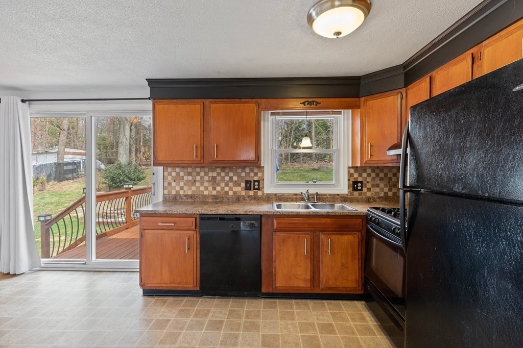 151 Garnet Street Springfield, MA 01129 - Photo 9 of 41 a kitchen with a sink stove and cabinets