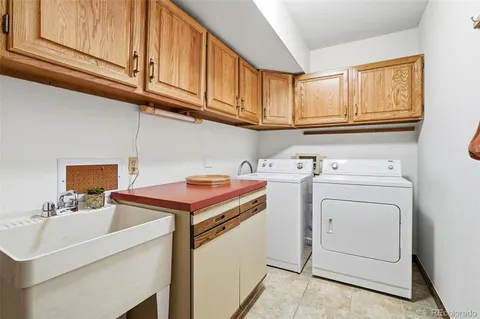 a utility room with cabinets washer and dryer
