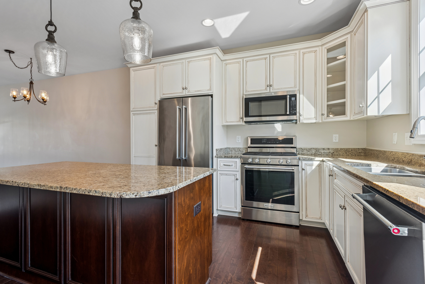 57 South 7th Street Geneva, IL 60134 - Photo 11 of 24 a kitchen with kitchen island granite countertop stainless steel appliances a stove cabinets and wooden floor