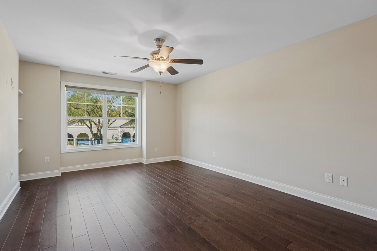 57 South 7th Street Geneva, IL 60134 - Photo 14 of 24 an empty room with wooden floor chandelier fan and windows