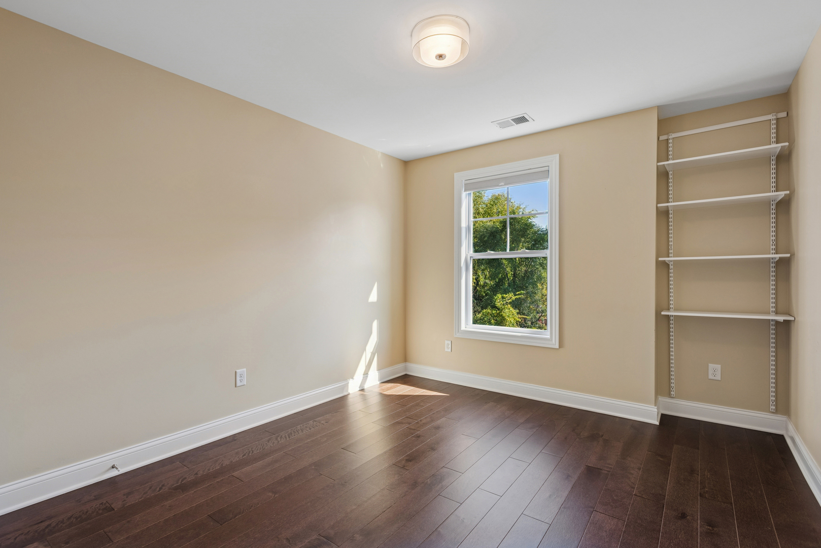57 South 7th Street Geneva, IL 60134 - Photo 18 of 24 a view of an empty room with a window and wooden floor