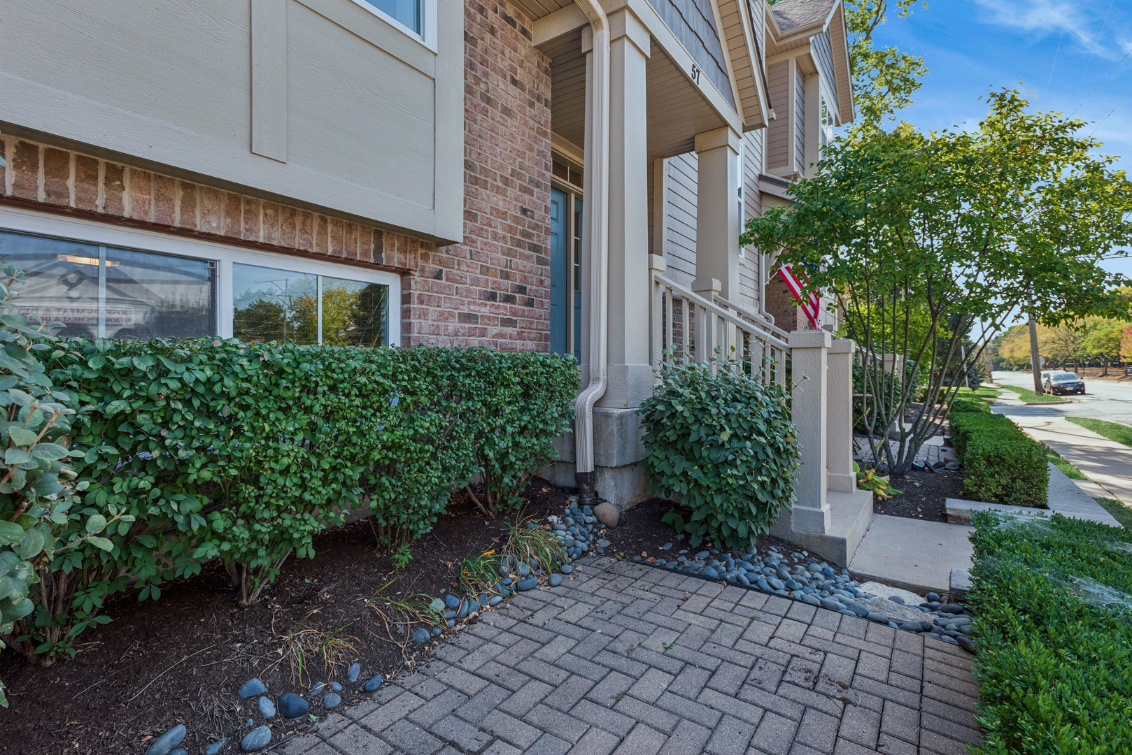 57 South 7th Street Geneva, IL 60134 - Photo 2 of 24 a view of a brick house with plants and large trees