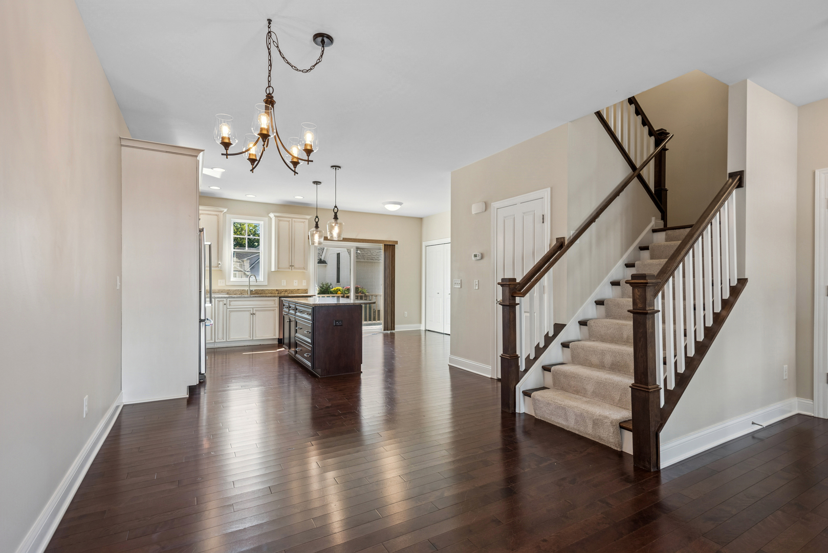 57 South 7th Street Geneva, IL 60134 - Photo 8 of 24 a view of a livingroom with wooden floor and staircase