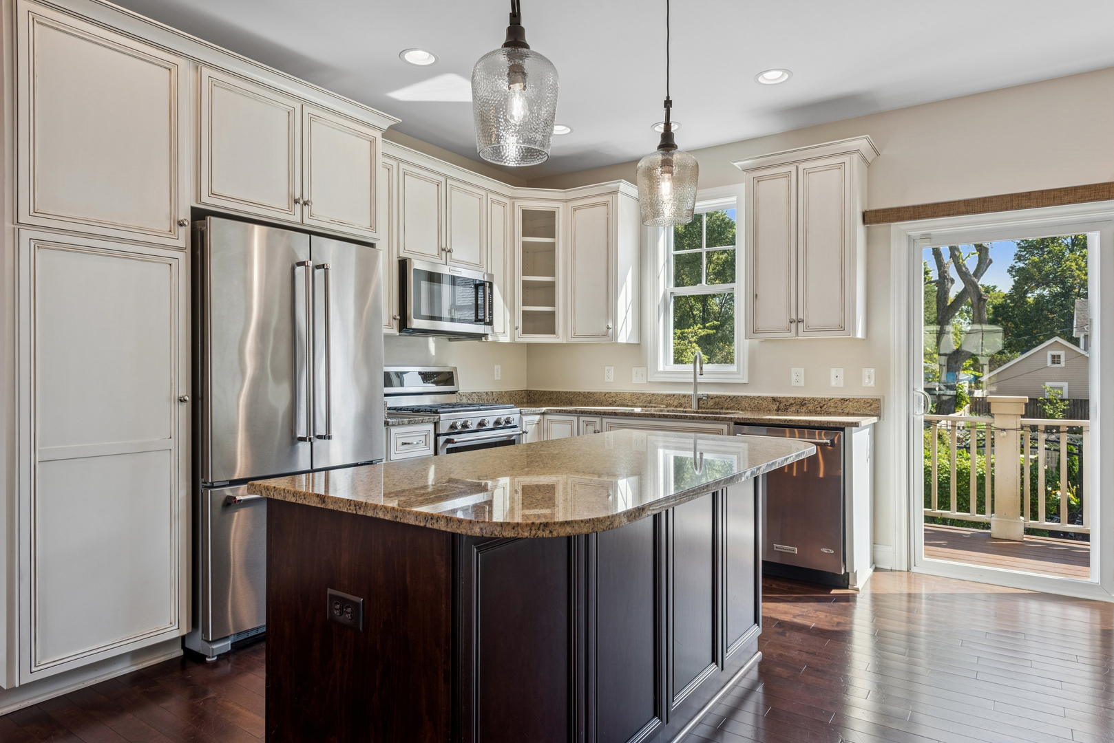 57 South 7th Street Geneva, IL 60134 - Photo 9 of 24 a kitchen with stainless steel appliances granite countertop a refrigerator a sink dishwasher a stove and a dining table with wooden floor