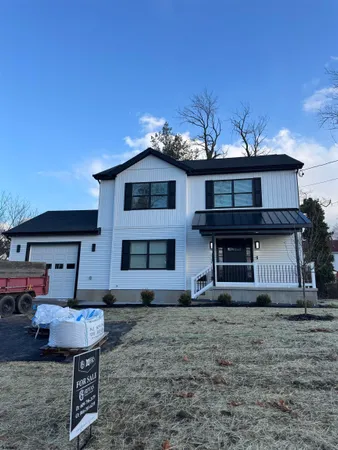 a view of a house with a yard and sitting space