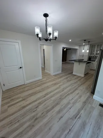 a view of a living room and kitchen with a wooden floor
