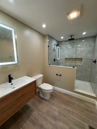 a bathroom with a sink a toilet and a mirror