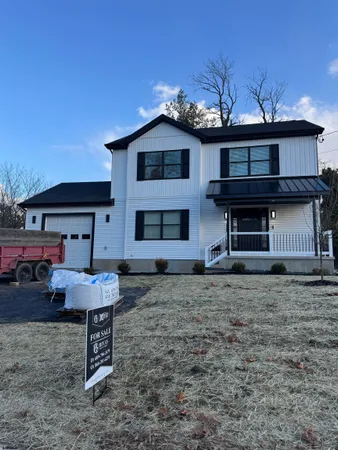 a view of a house with a bed and wooden fence