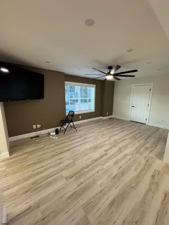 a view of a livingroom with a ceiling fan and window