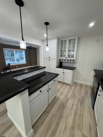 a kitchen with sink microwave and stove