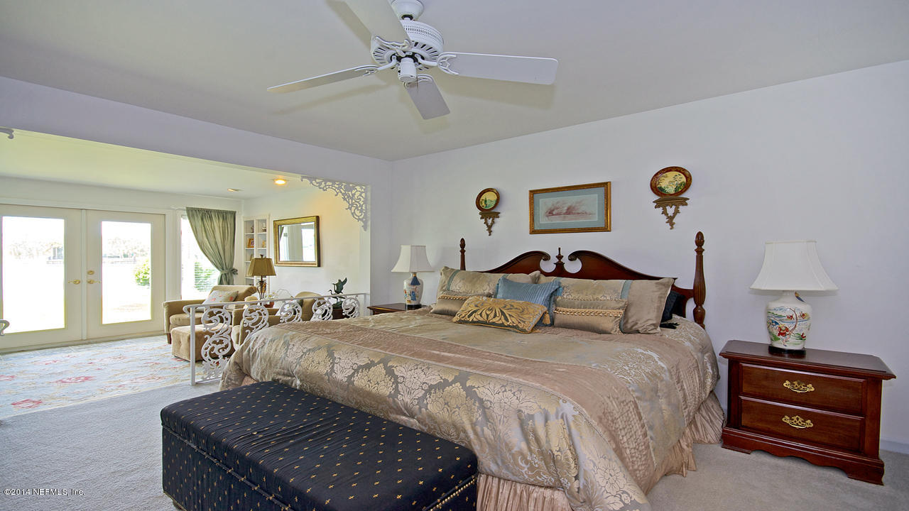 5 Solana Road Ponte Vedra Beach, FL 32082 - Photo 15 of 28 a bedroom with a bed and wooden floor