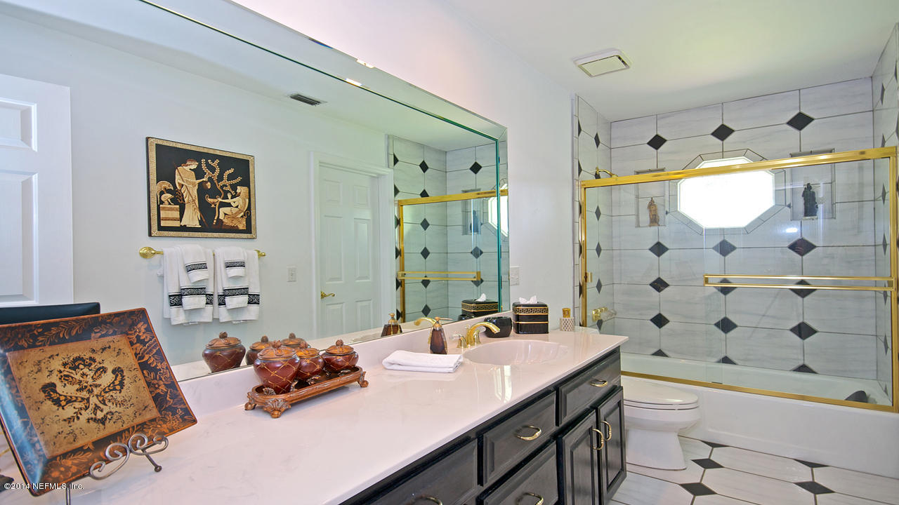 5 Solana Road Ponte Vedra Beach, FL 32082 - Photo 19 of 28 a bathroom with a sink double vanity and a shower