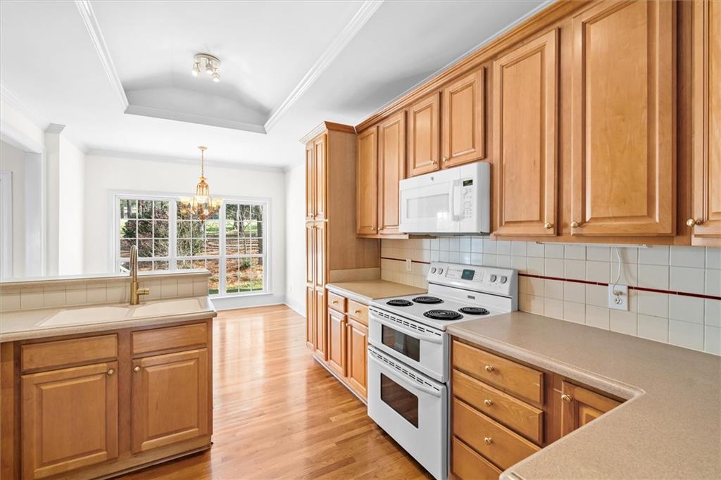 1030 Lakeview Parkway Villa Rica, GA 30180 - Photo 10 of 46 a kitchen with stainless steel appliances granite countertop a stove a sink and dishwasher with wooden cabinets