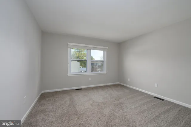 a view of a house with backyard sitting area and garden