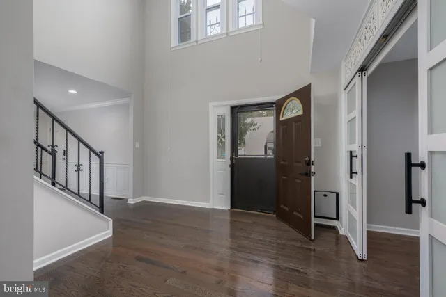 a view of an entryway with wooden floor and stairs