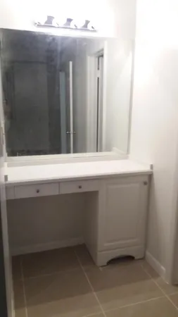 a bathroom with a toilet a sink and mirror