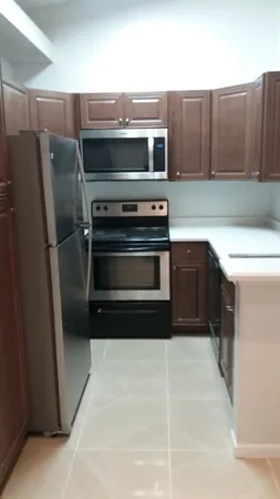 a kitchen with appliances and cabinets