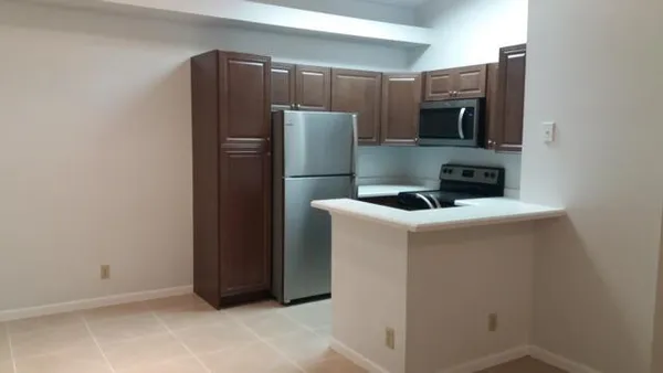 a kitchen with a refrigerator and a microwave
