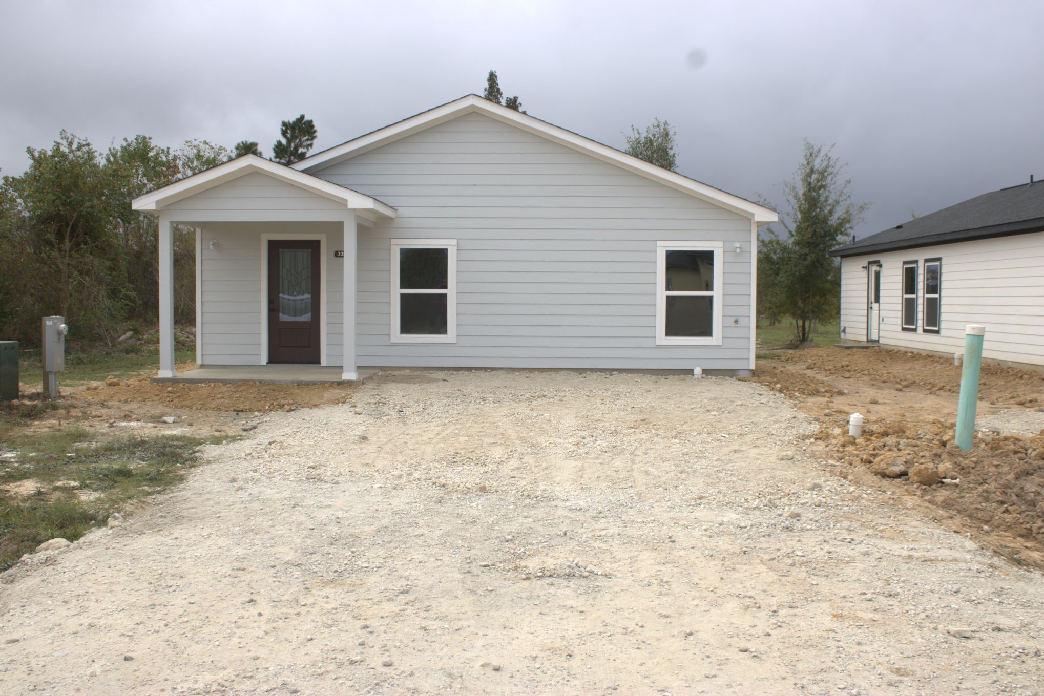 338 Road 5840 Cleveland, TX 77327 - Photo 1 of 12 a front view of a house with a yard and garage
