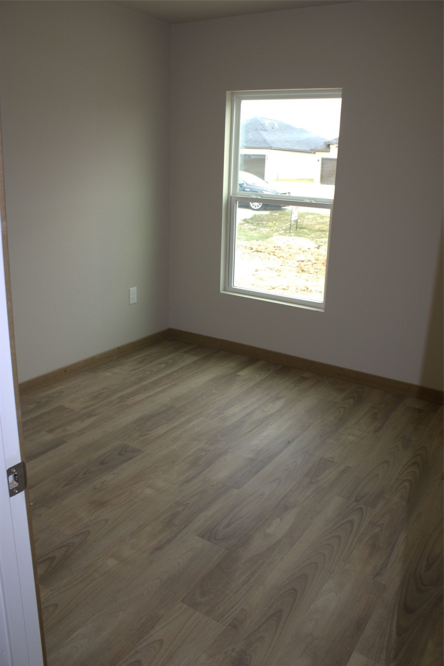 338 Road 5840 Cleveland, TX 77327 - Photo 6 of 12 an empty room with wooden floor and windows