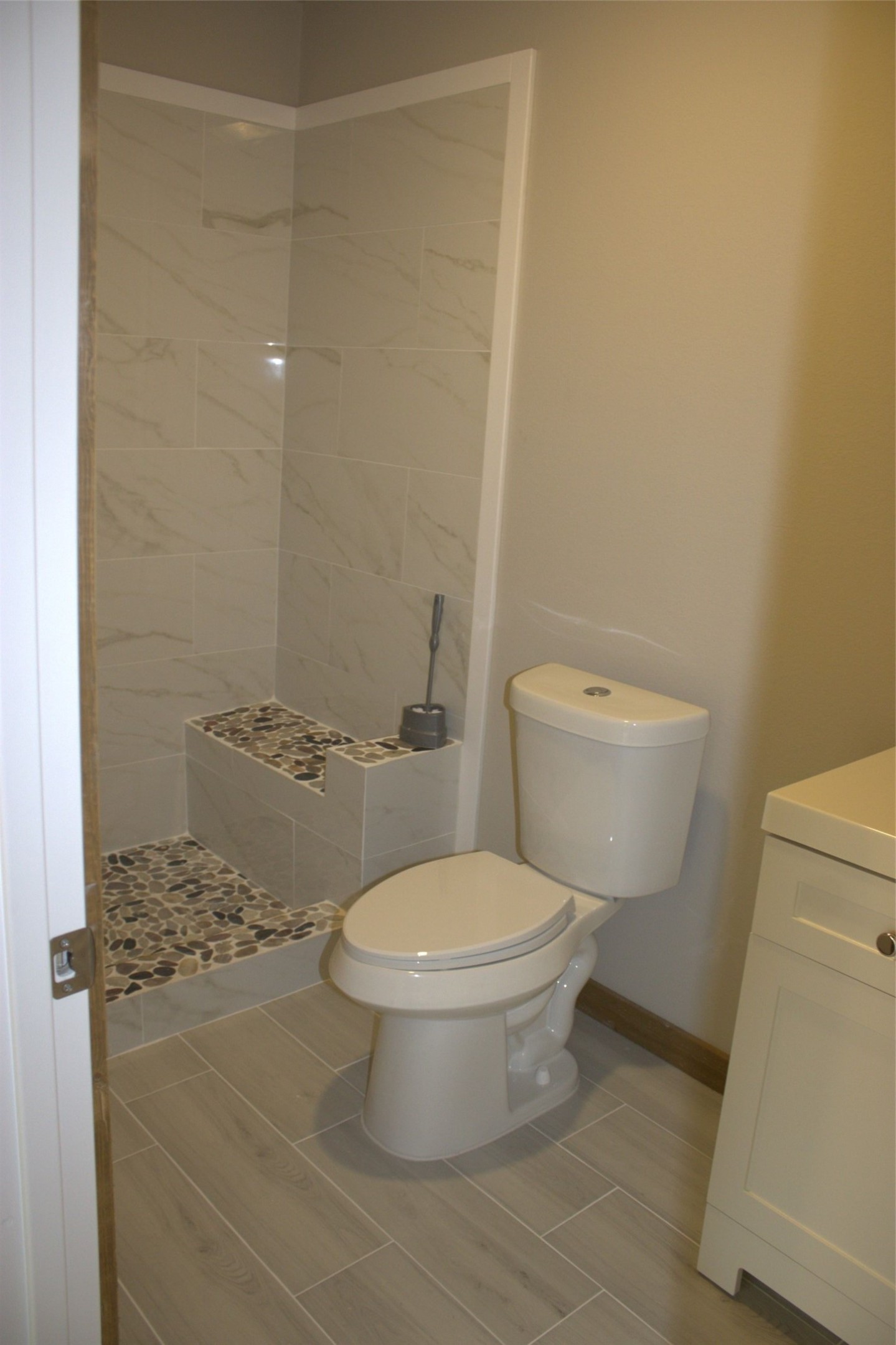 338 Road 5840 Cleveland, TX 77327 - Photo 7 of 12 a white toilet sitting next to a bathroom sink and vanity