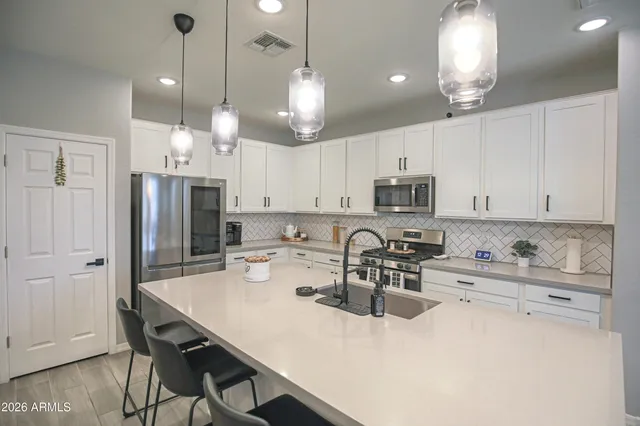 a large kitchen with a table and chairs