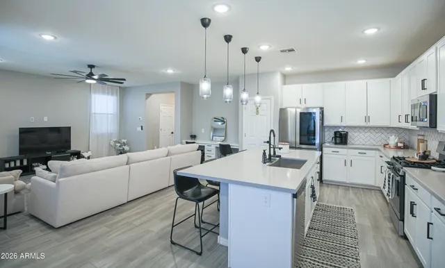 a kitchen with a sink a counter and chairs
