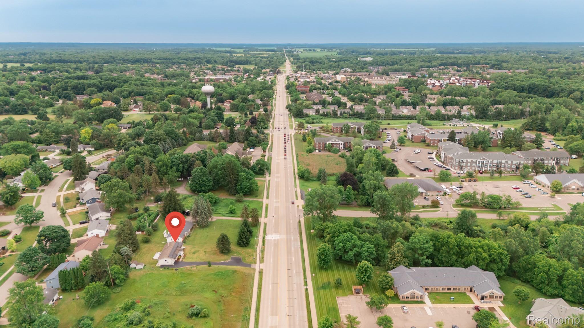 3882 Okemos Road Okemos, MI 48864 - Photo 48 of 50 Additional content
The image is an aerial view of a residential neighborhood with a street running through it