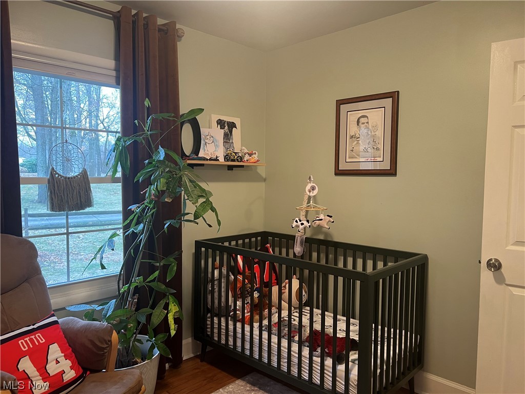 1935 Far View Road Akron, OH 44312 - Photo 16 of 25 Bedroom with a crib and dark wood-type flooring