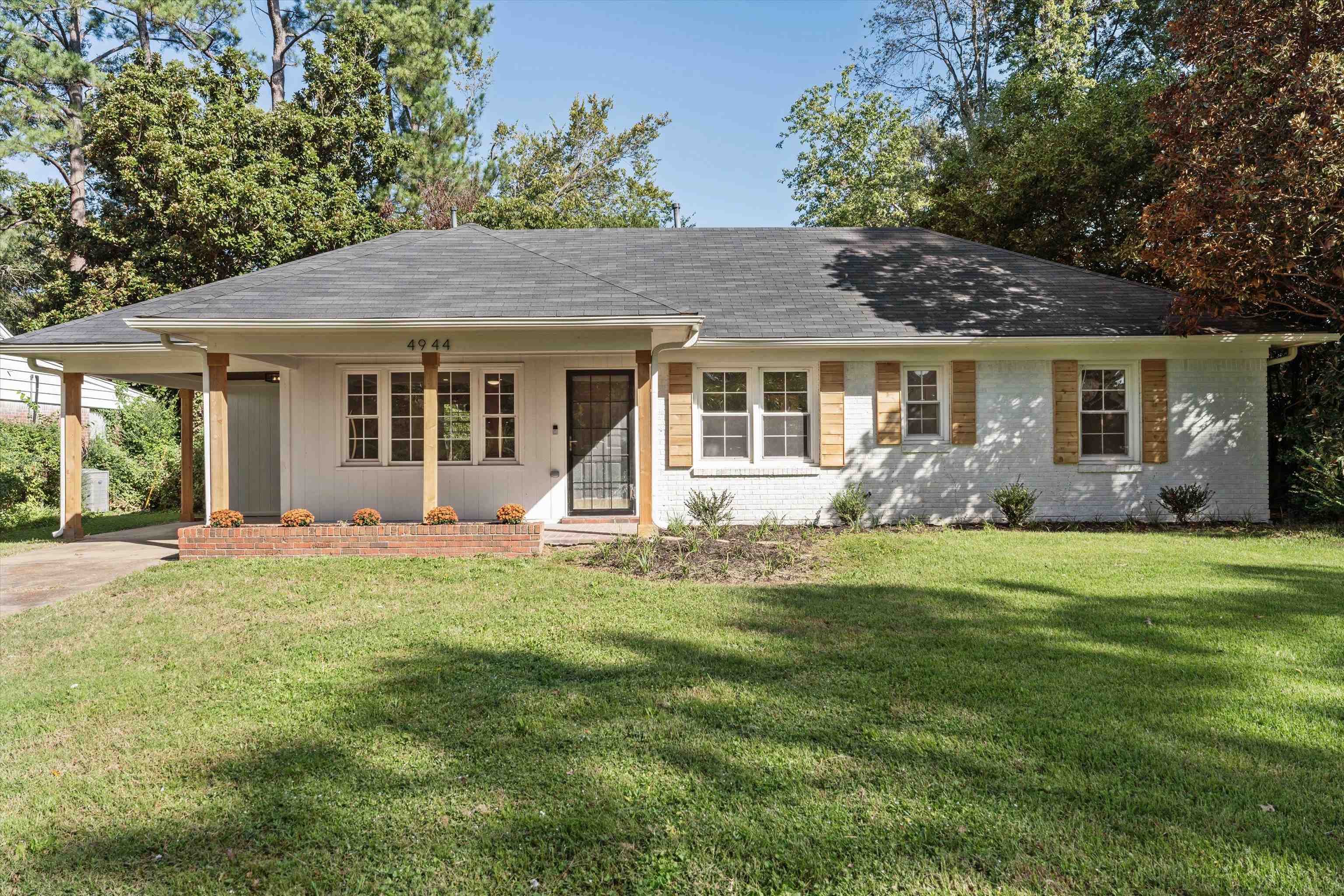 a front view of house with yard and green space