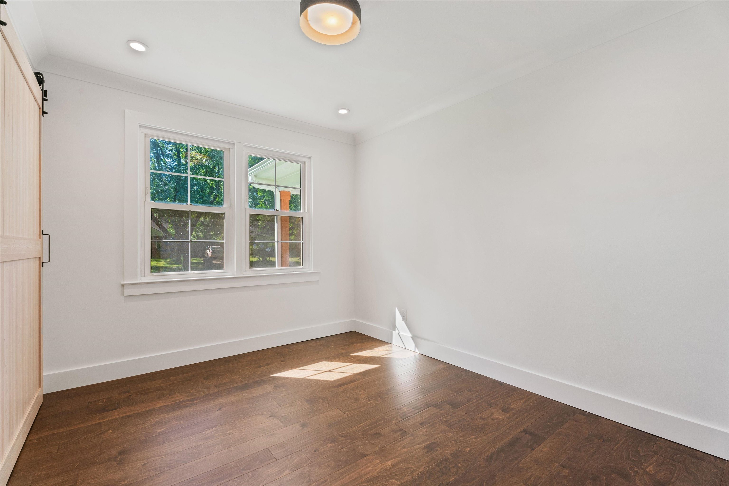 4944 Kaye Road Memphis, TN 38117 - Photo 18 of 25 an empty room with wooden floor and windows
