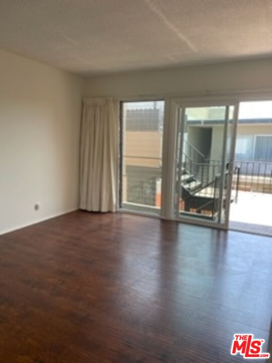 3739 McLaughlin Avenue Los Angeles, CA 90066 - Photo 6 of 11 an empty room with wooden floor and windows