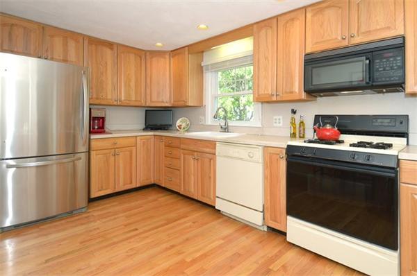 102 Standish Road Needham, MA 02492 - Photo 8 of 28 a kitchen with a sink a microwave a refrigerator and cabinets