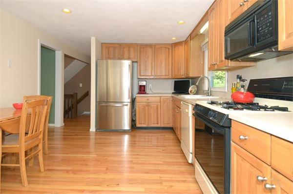 102 Standish Road Needham, MA 02492 - Photo 9 of 28 a kitchen with stainless steel appliances a refrigerator stove microwave and cabinets