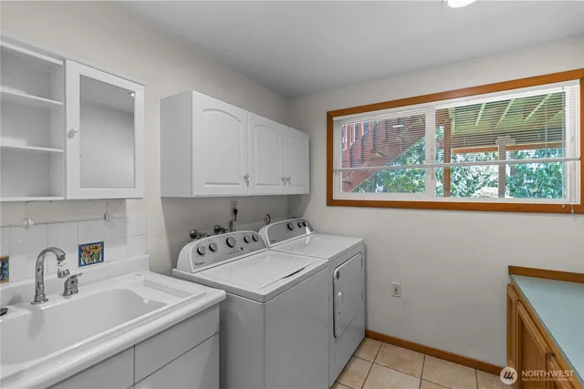 a utility room with sink dryer and washer