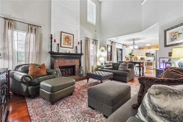 a living room with furniture fireplace and a large window
