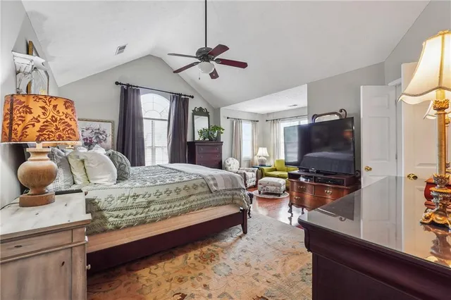 a bedroom with a bed and flat screen tv