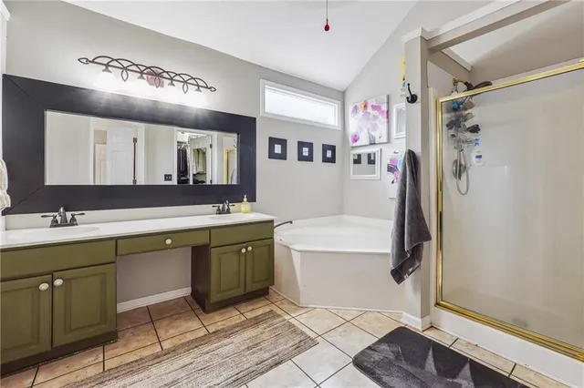 a spacious bathroom with a double vanity sink mirror and bathtub