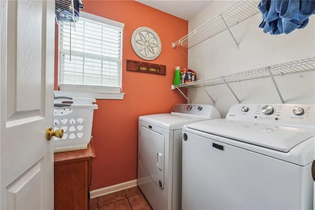a view of a chair and table under an umbrella in patio